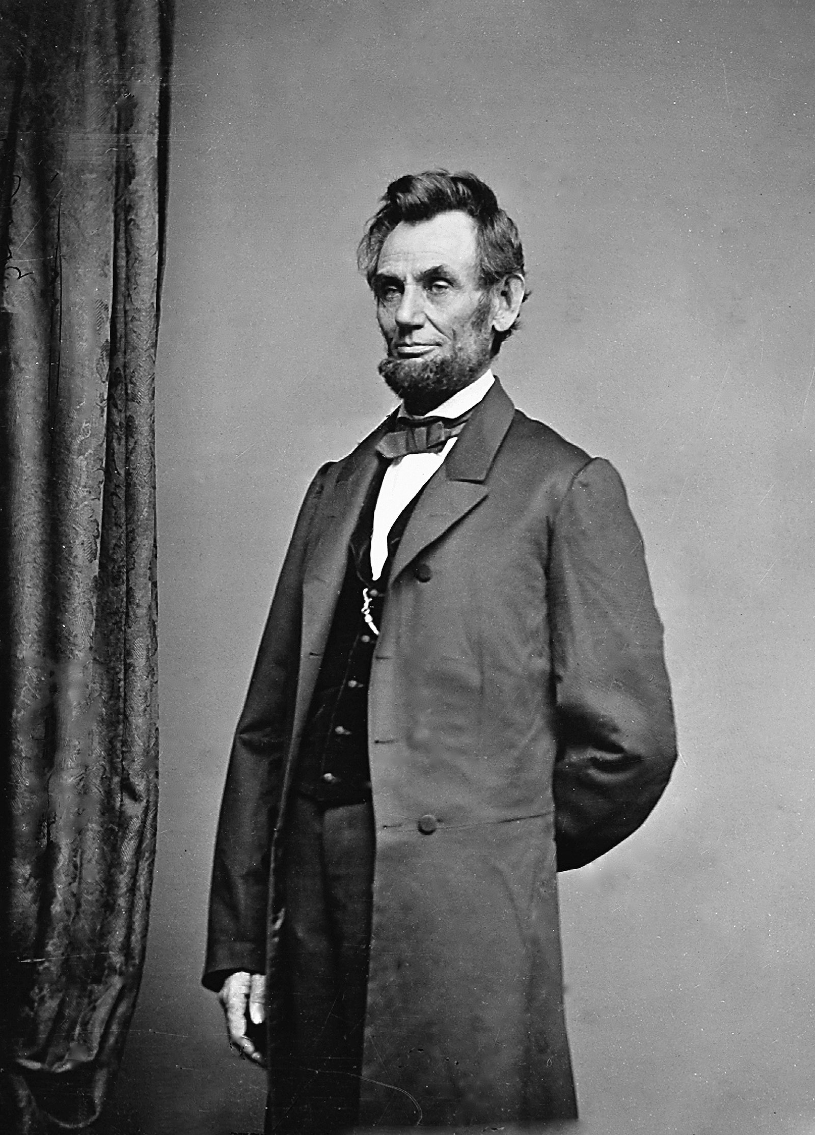 Image may contain Abraham Lincoln Clothing Coat Face Head Person Photography Portrait Adult and Overcoat