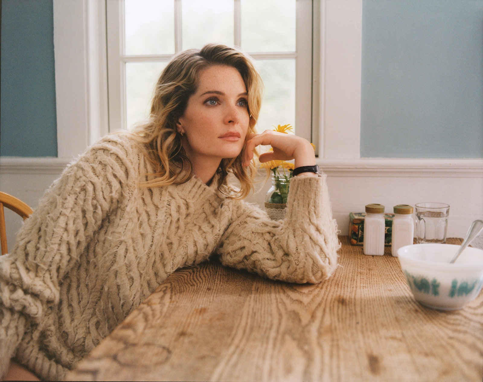 Meghann Fahy in a sweater by Chanel earrings and watch by Cartier.